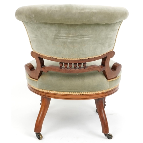 1103 - A late Victorian walnut framed nursing chair upholstered in green velour, 72cm H x 58cm W x 73cm D.