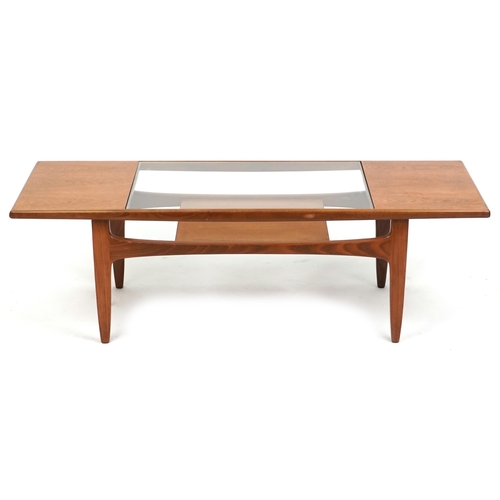 1011 - A G Plan teak coffee table with inset glass top above an under tier, 43cm H x 137cm W x 51cm D.