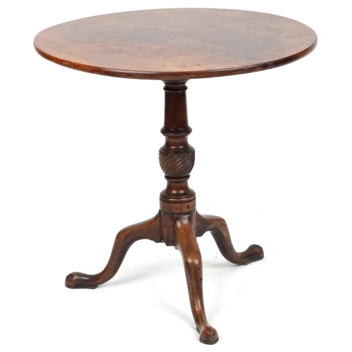 1006 - A George III mahogany tip top circular wine table raised on a turned and reeded support and tripod c... 