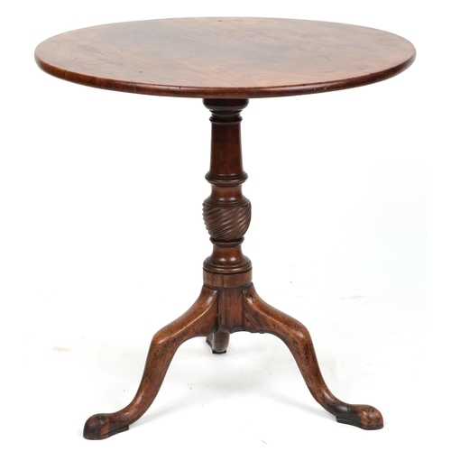 1006 - A George III mahogany tip top circular wine table raised on a turned and reeded support and tripod c... 