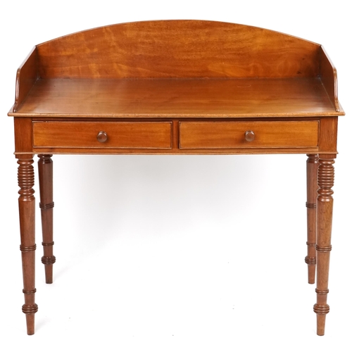 1018 - A late Victorian mahogany side table the three quarter gallery back above two drawers, raised on rin... 