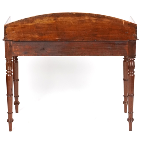 1018 - A late Victorian mahogany side table the three quarter gallery back above two drawers, raised on rin... 