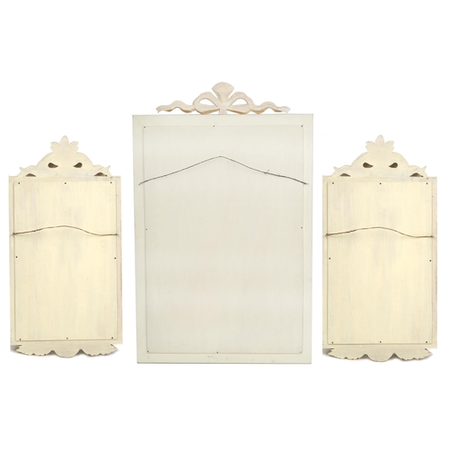 1057 - A modern white painted wall mirror, 96cm x 60cm, together with a similar smaller pair of wall mirror... 