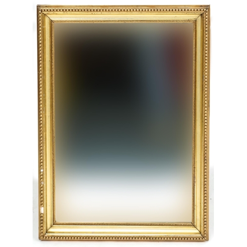 1110 - A late 20th century gilt framed rectangular wall mirror, 59cm x 46cm.