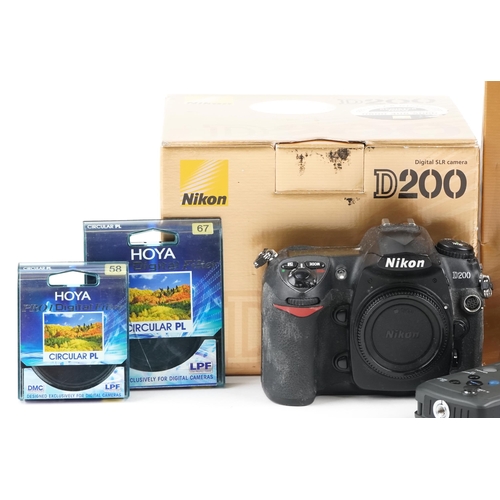 516 - Nikon D200 camera and camera accessories, some with boxes, including Nikkor 70-300mm lens.