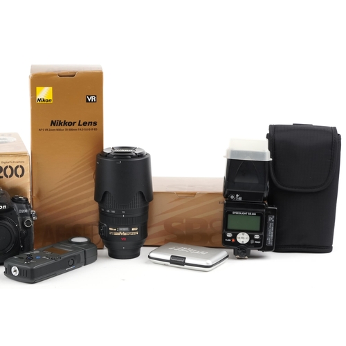 516 - Nikon D200 camera and camera accessories, some with boxes, including Nikkor 70-300mm lens.