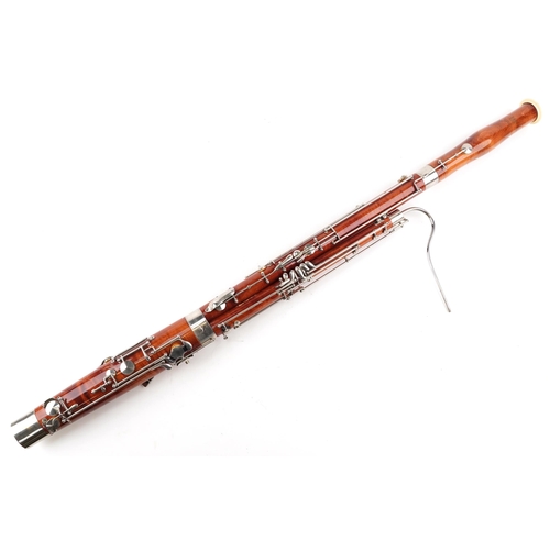  A Boosey & Hawkes 400 four piece bassoon with fitted protective case, some sections numbered 300.