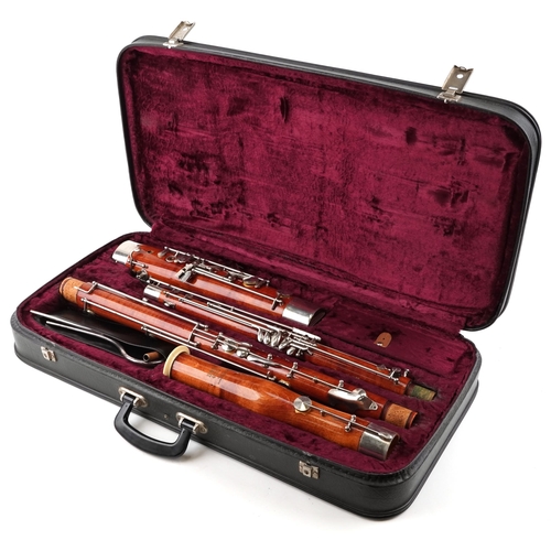 A Boosey & Hawkes 400 four piece bassoon with fitted protective case, some sections numbered 300.