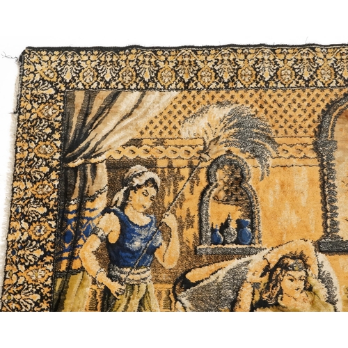 1112 - An early to mid 20th century Middle Eastern tapestry wall hanging depicting a lady being fanned and ... 