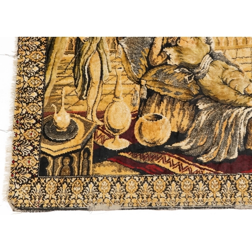 1112 - An early to mid 20th century Middle Eastern tapestry wall hanging depicting a lady being fanned and ... 