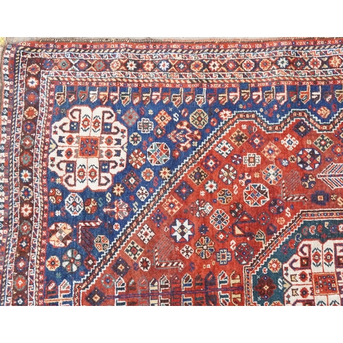 1113 - A Qashqai rug, mid 20th century, the blue field with a central medallion flanked by a border of rose... 