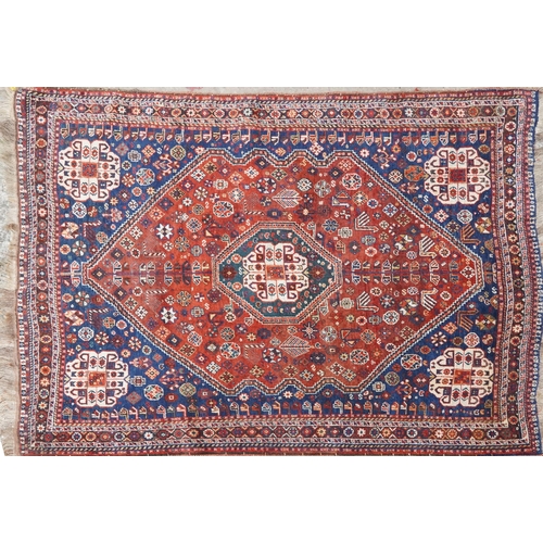 1113 - A Qashqai rug, mid 20th century, the blue field with a central medallion flanked by a border of rose... 