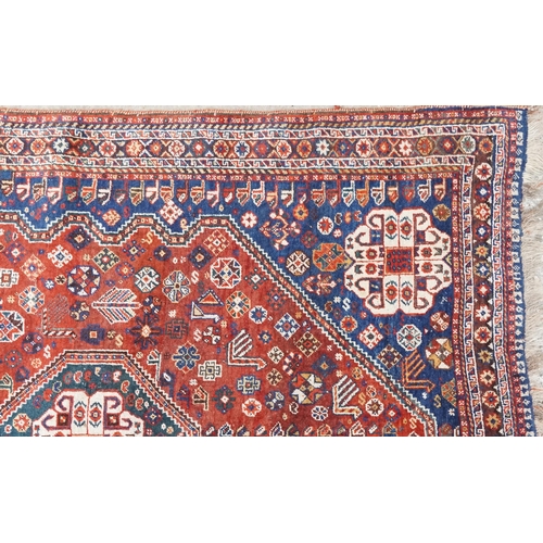 1113 - A Qashqai rug, mid 20th century, the blue field with a central medallion flanked by a border of rose... 