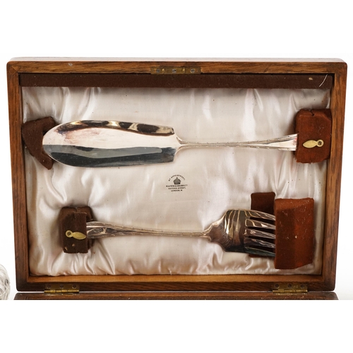 1390 - A Mappin & Webb oak canteen of fish knives, forks and servers together with two glass preserve jars ... 