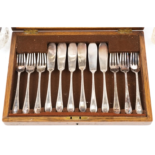 1390 - A Mappin & Webb oak canteen of fish knives, forks and servers together with two glass preserve jars ... 