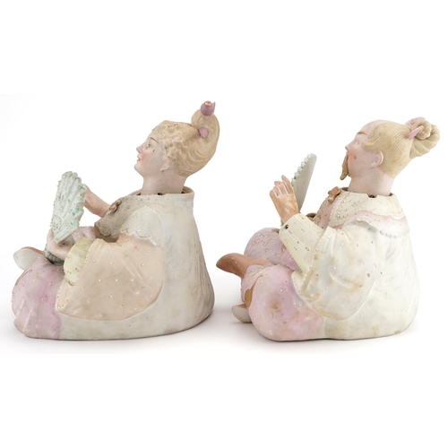 29 - A pair of late 19th century German bisque nodding Chinese figures, each holding a fan and in a kneel... 