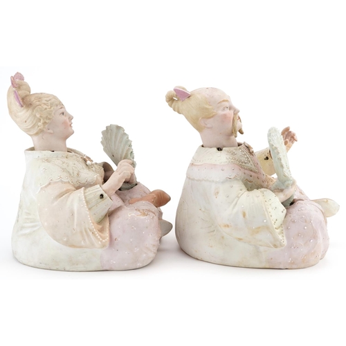 29 - A pair of late 19th century German bisque nodding Chinese figures, each holding a fan and in a kneel... 