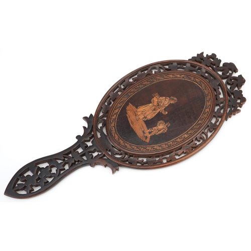 87 - A late 19th century Italian Sorrento Ware olive wood hand mirror with pierced decoration.