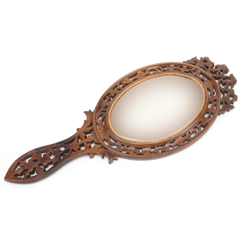 87 - A late 19th century Italian Sorrento Ware olive wood hand mirror with pierced decoration.