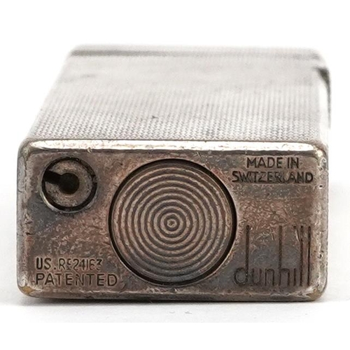 75 - A silver plated Dunhill engine turned pocket lighter numbered RE24163, 6.5cm high.