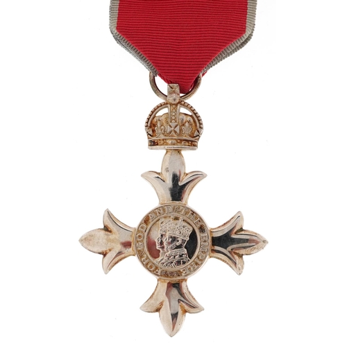 2400 - A George V MBE medal with ribbon housed in a Toye, Kenning & Spencer Limited box.