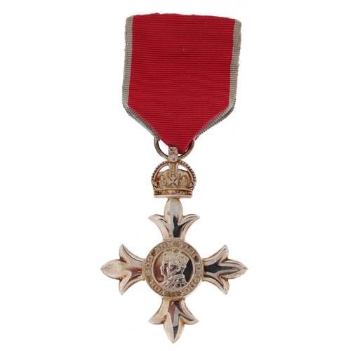 2400 - A George V MBE medal with ribbon housed in a Toye, Kenning & Spencer Limited box.