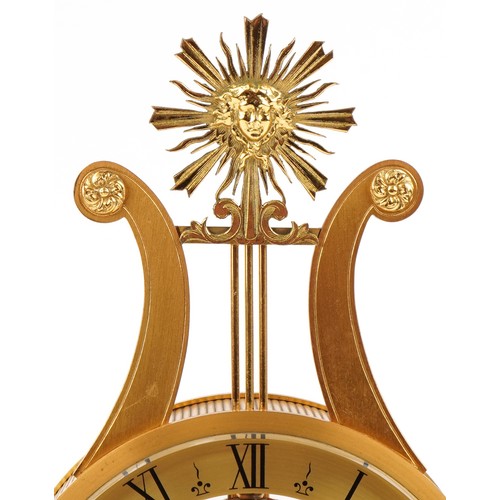 163 - A 20th century gilt bronze and white marble mantle clock with Roman numerals, the base mounted with ... 