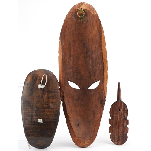 1376 - Three African carved hardwood masks, late 20th century, the largest 51cm in length.