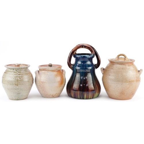 1384 - A group of 20th century studio pottery jars and covers together with a blue and green glazed pottery... 