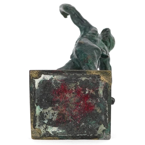 73 - A 20th century green patinated bronze figure of a faun, 15cm high.