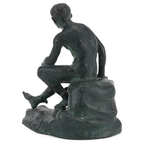 72 - A 20th century green patinated bronze figure of Apollo seated on a rock, 10cm high.