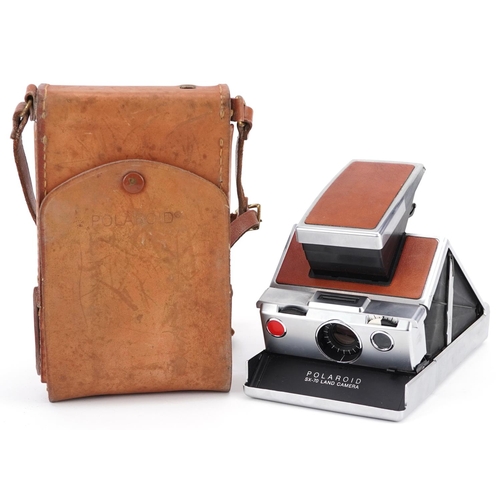  A Polaroid SX-70 Land camera with tan leather case.