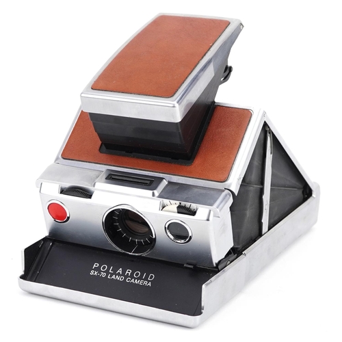  A Polaroid SX-70 Land camera with tan leather case.