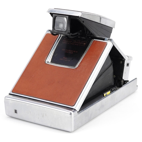  A Polaroid SX-70 Land camera with tan leather case.