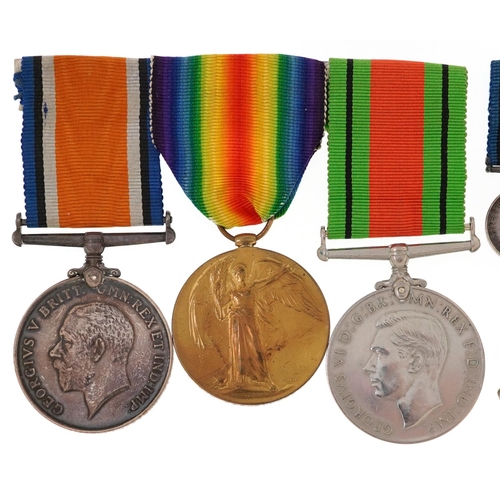 2401 - British military World War I medal pair and World War II Defence medal with dress medals, cap badges... 