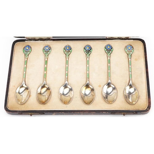 390 - Turner & Simpson, a set of six George V silver and enamel teaspoons with floral terminals housed in ... 