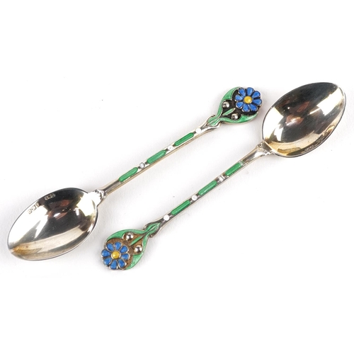 390 - Turner & Simpson, a set of six George V silver and enamel teaspoons with floral terminals housed in ... 