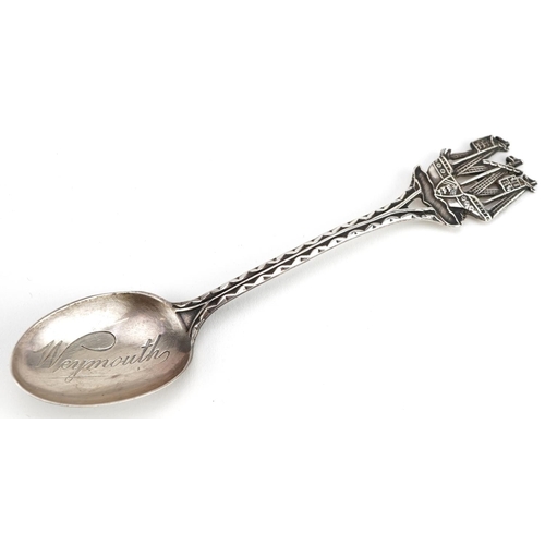 459 - A continental white metal embossed cream jug and a silver teaspoon with ship design terminal, the sp... 