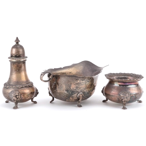 446 - Silver items comprising a baluster caster, three footed salt with lion mask and paw feet retailed by... 