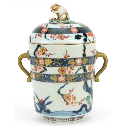 A Japanese Imari porcelain lidded jar, Meiji period, the lid mounted with a rat, 23cm high x 13cm in diameter.