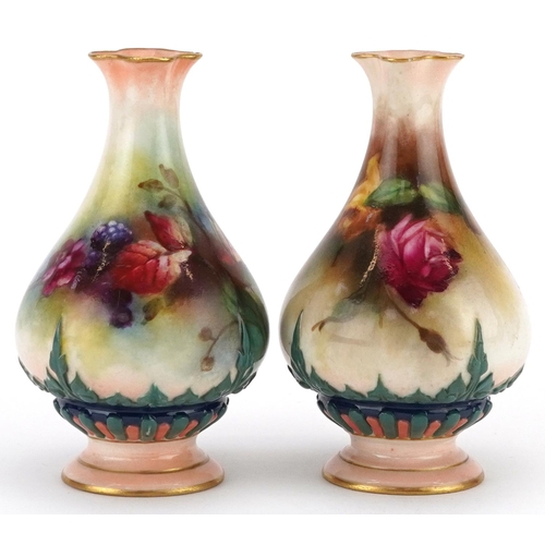 A pair of Royal Worcester porcelain hand painted diminutive vases, one decorated with roses, the other with brambles, 10.5cm high