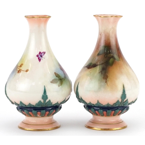  A pair of Royal Worcester porcelain hand painted diminutive vases, one decorated with roses, the oth... 