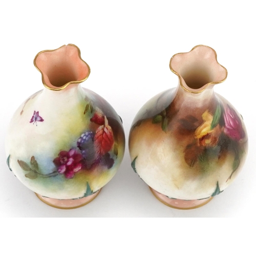  A pair of Royal Worcester porcelain hand painted diminutive vases, one decorated with roses, the oth... 