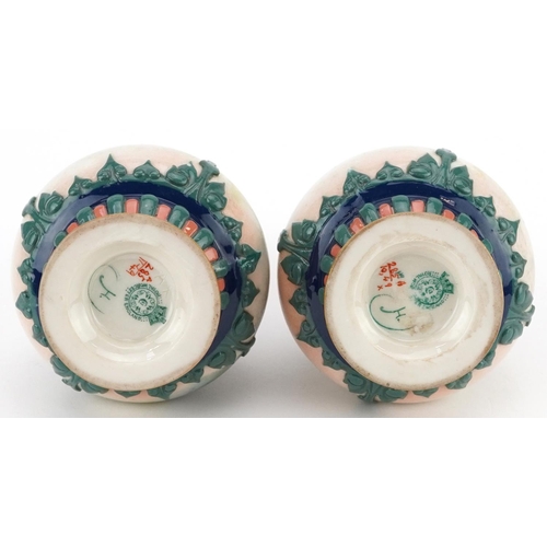  A pair of Royal Worcester porcelain hand painted diminutive vases, one decorated with roses, the oth... 