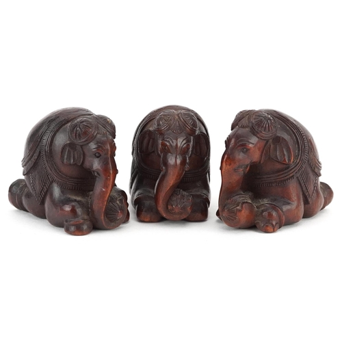 118 - Three Indian carved hardwood kneeling elephants, 20th century, 4cm high.