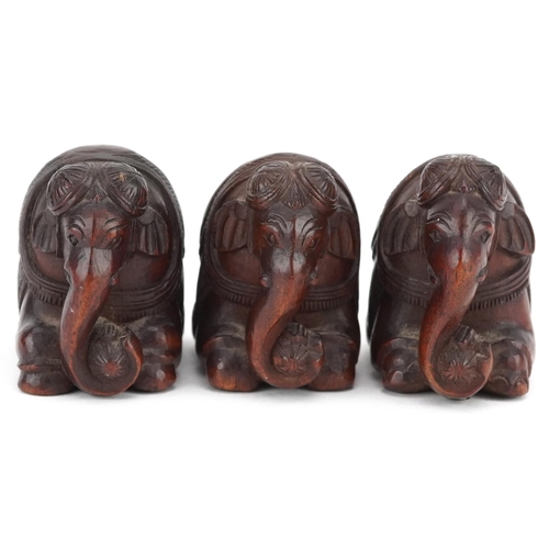 118 - Three Indian carved hardwood kneeling elephants, 20th century, 4cm high.