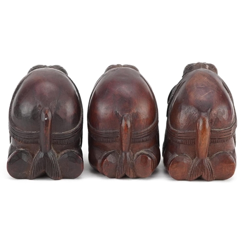 118 - Three Indian carved hardwood kneeling elephants, 20th century, 4cm high.