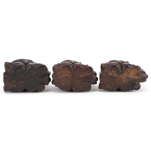 118 - Three Indian carved hardwood kneeling elephants, 20th century, 4cm high.