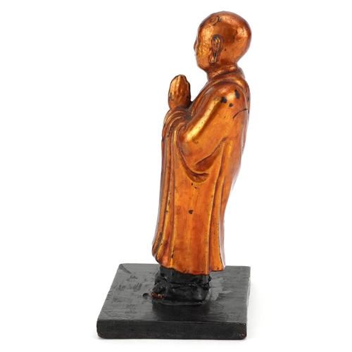 154 - A Japanese carved softwood and gilded figure of a sage, 20th century, mounted on a later wooden base... 