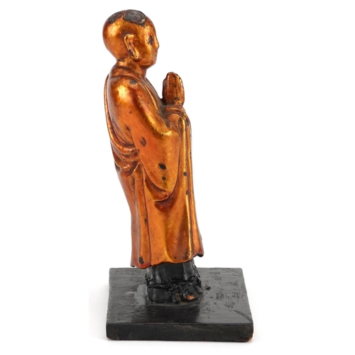 154 - A Japanese carved softwood and gilded figure of a sage, 20th century, mounted on a later wooden base... 